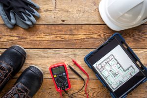 Electrician tools laid out on the floor | Featured image for The Importance of Electrical Maintenance blog for Latched Electrical Solutions.